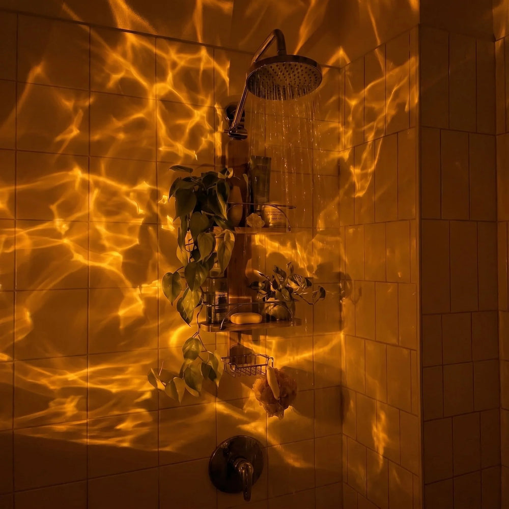 Warm amber light rippling across dark bathroom tiles